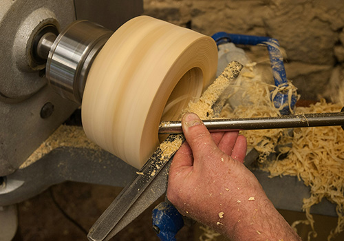 man using a wood lathe